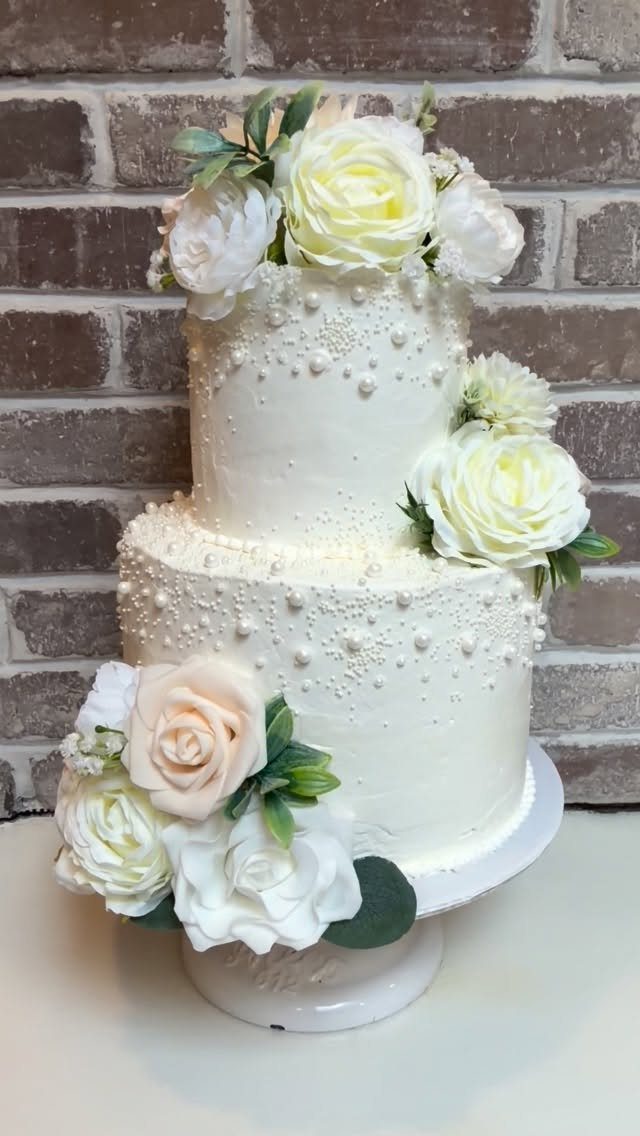 Wedding Cake Photo Ideas: 6 Designs for Every Style 6 Two-tier white wedding cake with pearl accents and fresh white and peach roses.