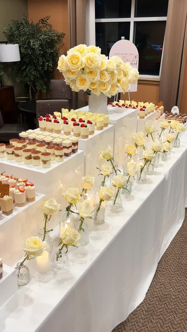 19 Wedding Decorations at Home: DIY Ideas to Try 11 Dessert table with mini cakes, yellow roses, and candles on white linens