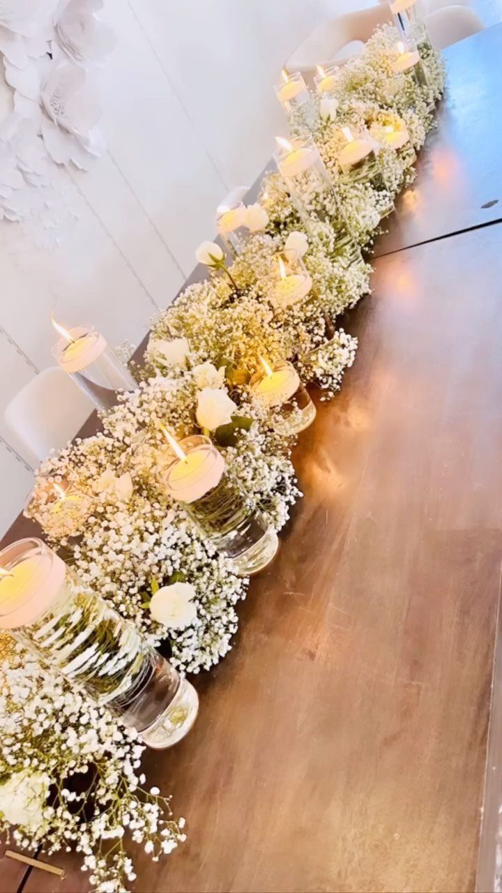 19 Wedding Decorations at Home: DIY Ideas to Try 3 White baby's breath flower runner with lit tea light candles on a wooden table