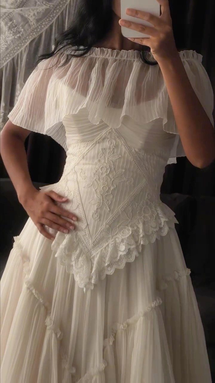 Vintage-inspired white wedding dress with lace bodice and tiered tulle skirt.