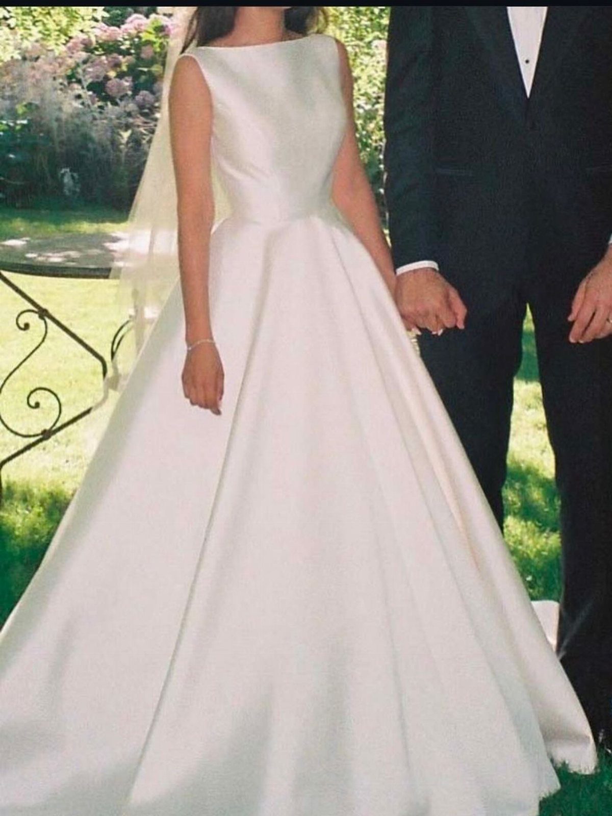 Wedding Dresses Elegant and Classy: 14 Gown Styles 6 Woman in a white satin boat neck wedding gown standing with a groom.