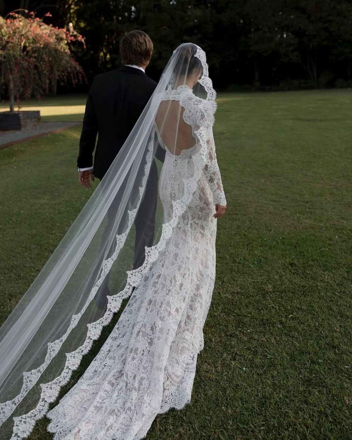 Wedding Dresses Elegant and Classy: 14 Gown Styles 8 Bride in a long sleeve lace wedding gown and veil walking with groom.