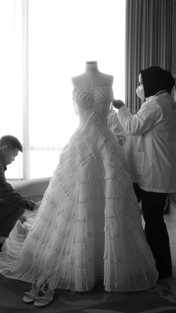 Wedding Dresses Elegant and Classy: 14 Gown Styles 9 Strapless wedding gown on a mannequin featuring intricate vertical pearl detailing and embellishments.