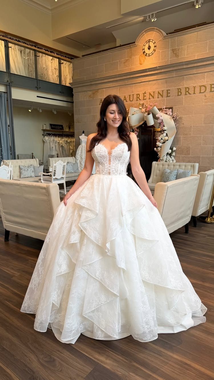 Wedding Dresses Elegant and Classy: 14 Gown Styles 7 Woman in a white sweetheart neckline ball gown with a tiered lace skirt.