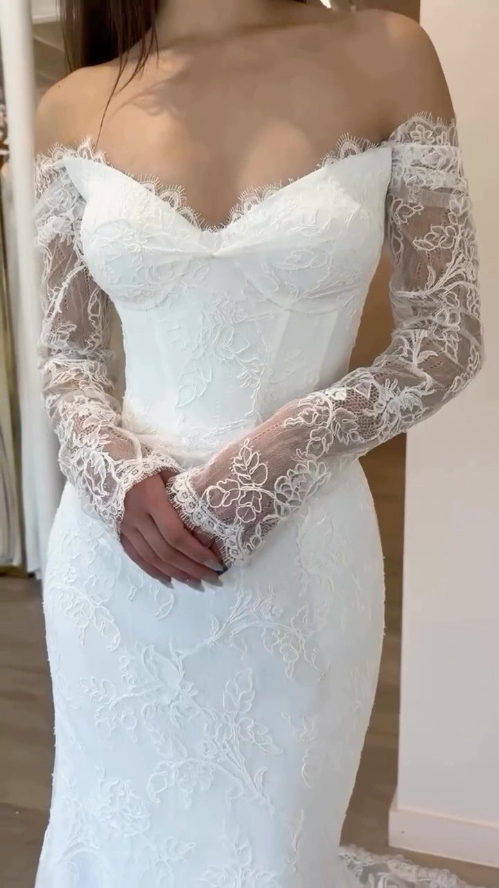 Wedding Dresses Elegant and Classy: 14 Gown Styles 11 Off-the-shoulder white wedding gown with long lace sleeves and floral embroidery.