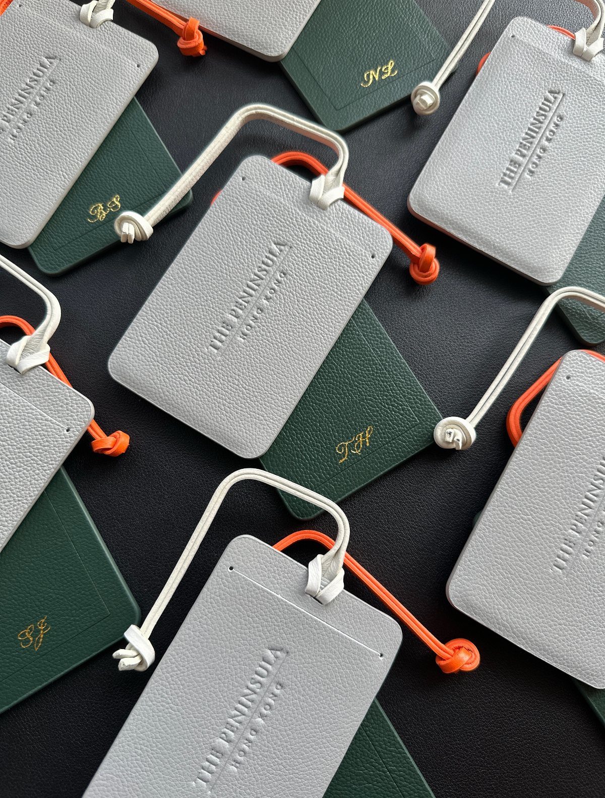 30 Wedding Guest Keepsakes Your Guests Will Actually Use 8 Grey and green leather luggage tags with embossed text and gold initials.