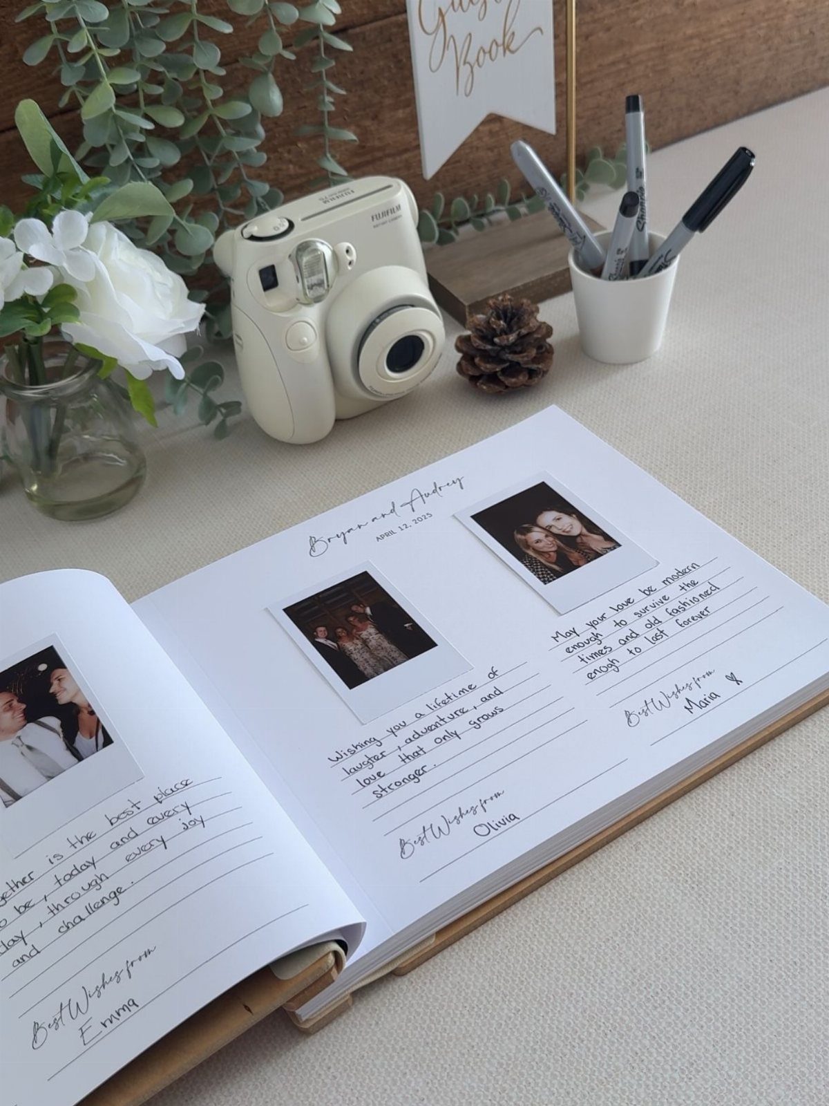 30 Wedding Guest Keepsakes Your Guests Will Actually Use 6 Instant camera and guest book with Polaroid photos and handwritten notes on a table.