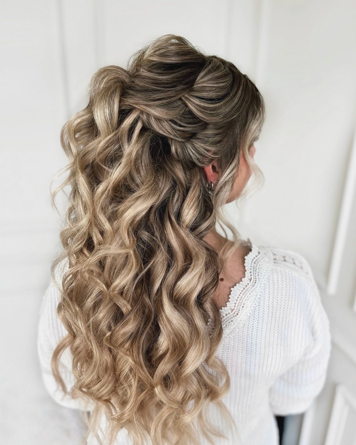 Wedding Hair and Makeup Ideas: 8 Looks for Every Bride 4 Blonde curly hair styled in a half-up bridal look with elegant braids.