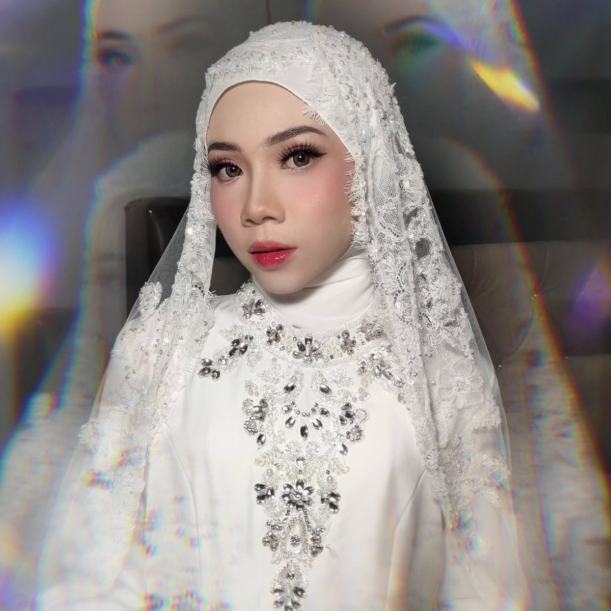 Wedding Hair and Makeup Ideas: 8 Looks for Every Bride 5 Woman in white bridal hijab and lace dress with professional wedding makeup