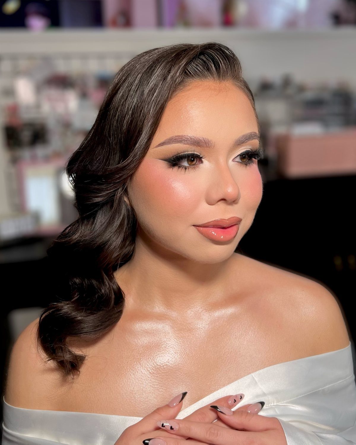 Wedding Hair and Makeup Ideas: 8 Looks for Every Bride 2 Woman with elegant wavy brown hair and soft glam makeup wearing white satin.