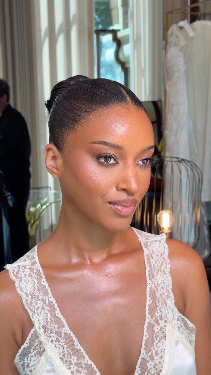 Wedding Hair and Makeup Ideas: 8 Looks for Every Bride 3 Woman with sleek high bun and soft glam makeup wearing white lace bridal gown