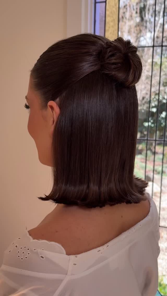 Wedding Hair Styles for Straight Hair: 9 Ideas 8 Woman with straight dark brown hair in a half-up bun wearing white clothing.