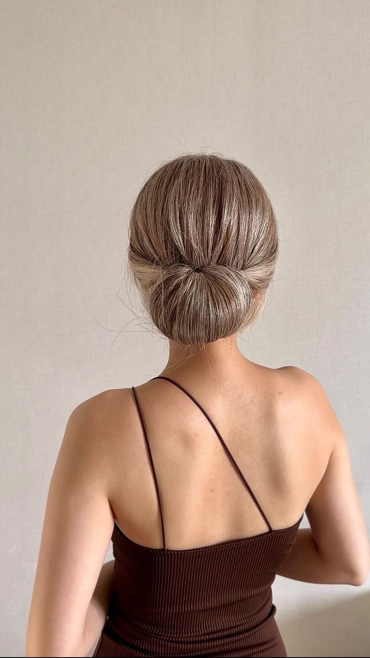 Wedding Hair Styles for Straight Hair: 9 Ideas 2 Woman with light brown hair styled in a sleek low bun from behind