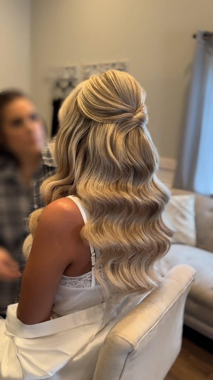 Blonde hair styled in glamorous retro waves with a half-up top section.