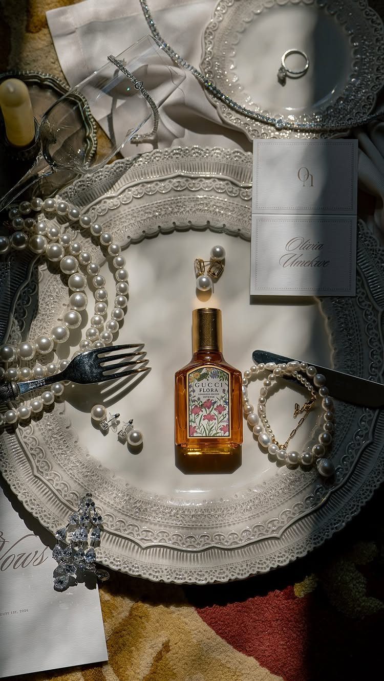 17 Wedding Ideas Pictures to Show Your Photographer 6 Wedding accessories including pearls, rings, and perfume arranged on a white lace plate.