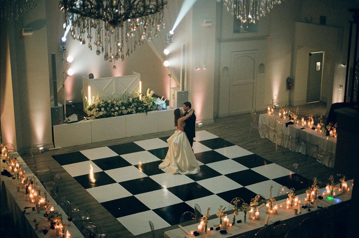 17 Wedding Ideas Pictures to Show Your Photographer 8 Bride and groom dancing on a checkered floor in a candlelit wedding reception hall.