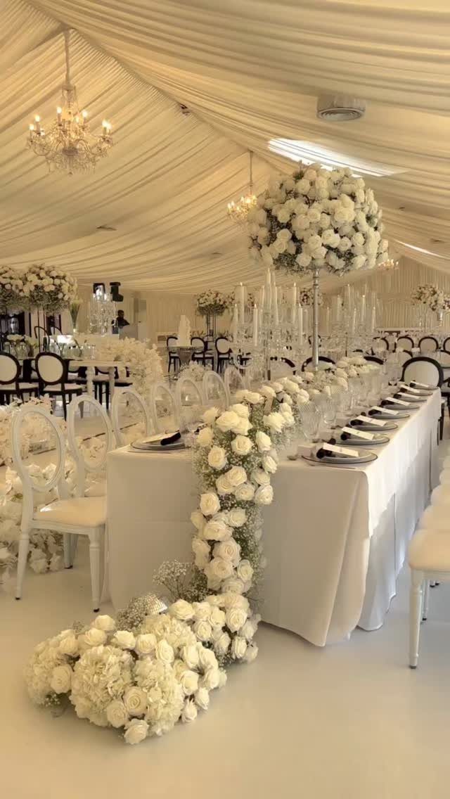 17 Wedding Ideas Pictures to Show Your Photographer 3 Long white wedding table with cascading white floral runner and elegant chandeliers.