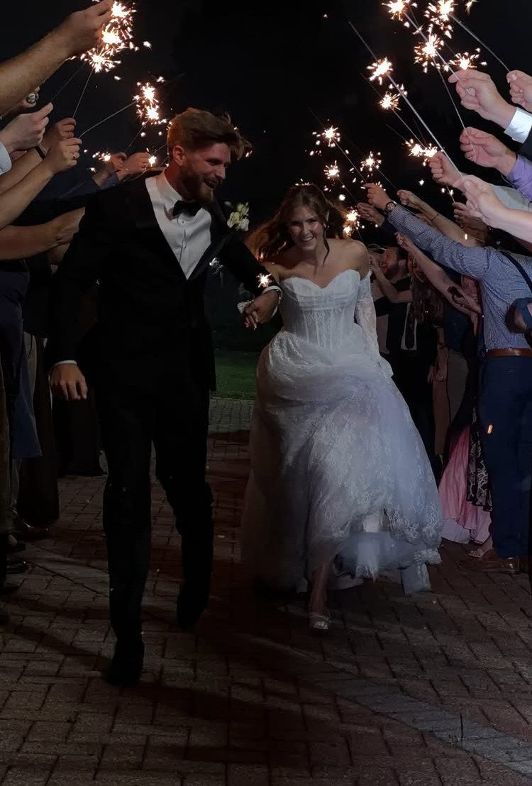 17 Wedding Ideas Pictures to Show Your Photographer 5 Bride and groom walking through a sparkler send-off tunnel at night on brick path.