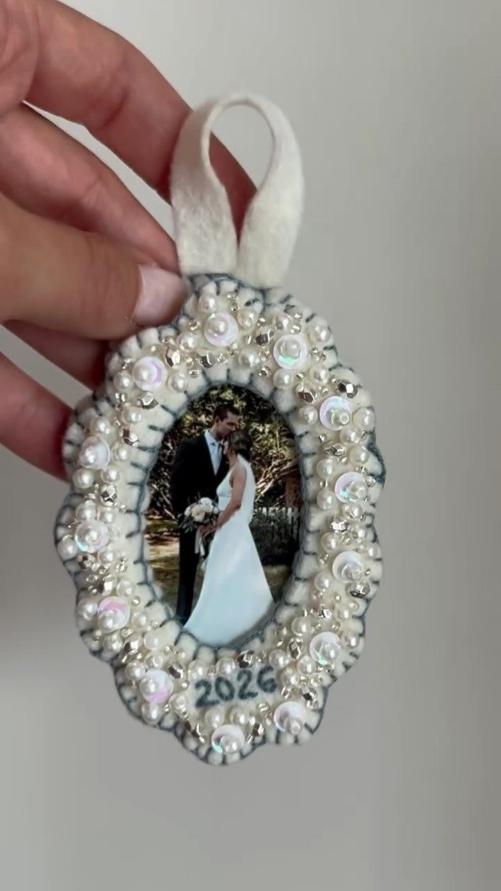 Pearl embellished wedding ornament featuring a photo of a bride and groom.
