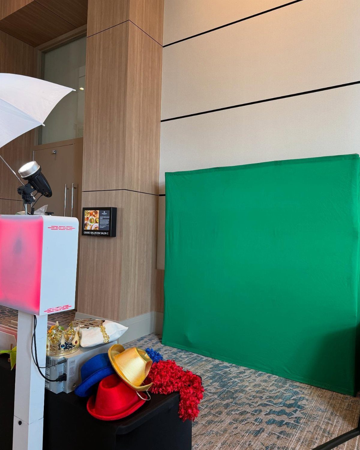 Best Wedding Photo Station Ideas: 8 Booths and Backdrops 8 Photo booth setup with green screen, studio lighting, and colorful party prop hats.