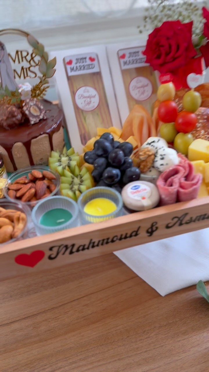 22 Wedding Present Ideas for Couples to Treasure 21 Personalized wooden gift tray with cake, fruits, cheeses, and Just Married cards.