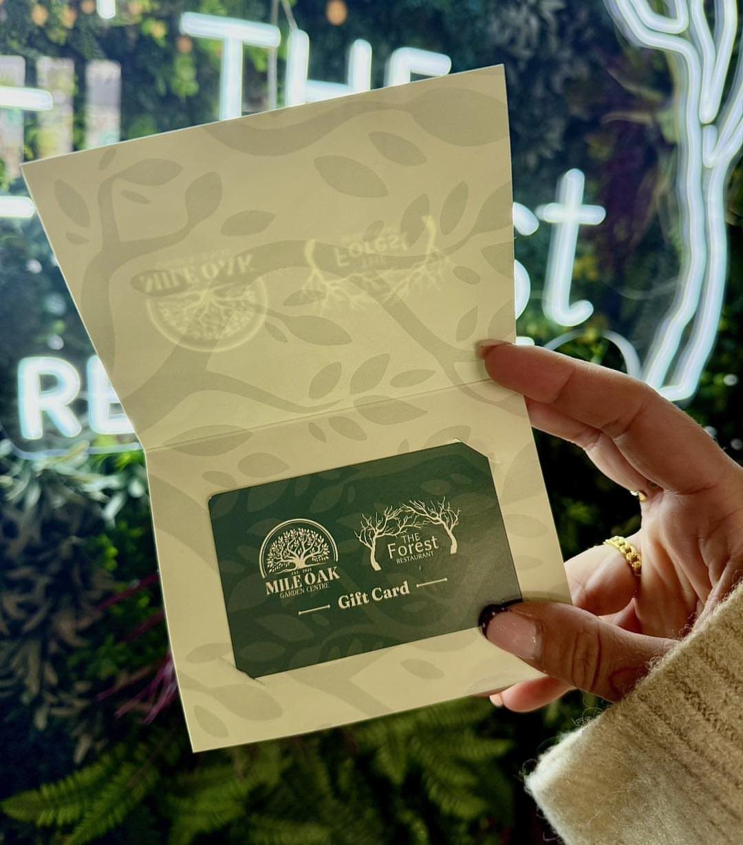 22 Wedding Present Ideas for Couples to Treasure 7 Green gift card from The Forest held inside a decorative card folder.