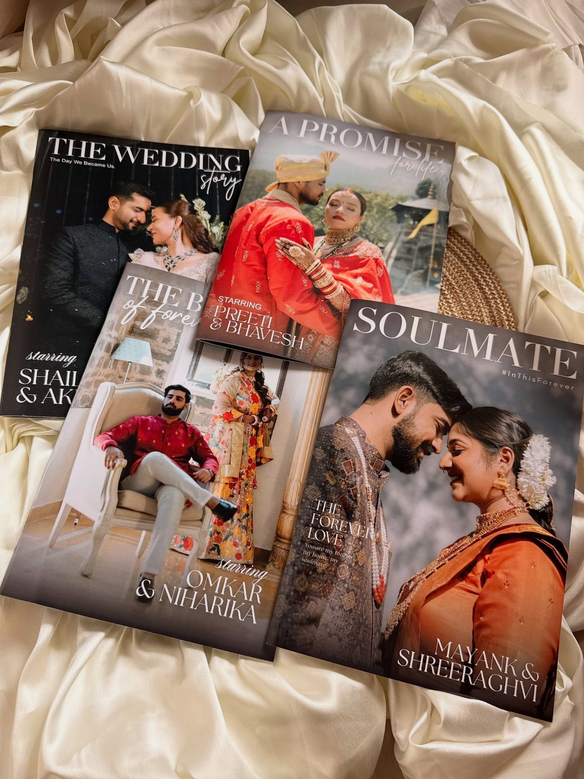 22 Wedding Present Ideas for Couples to Treasure 22 Four wedding photo books with couple portraits resting on white draped fabric.