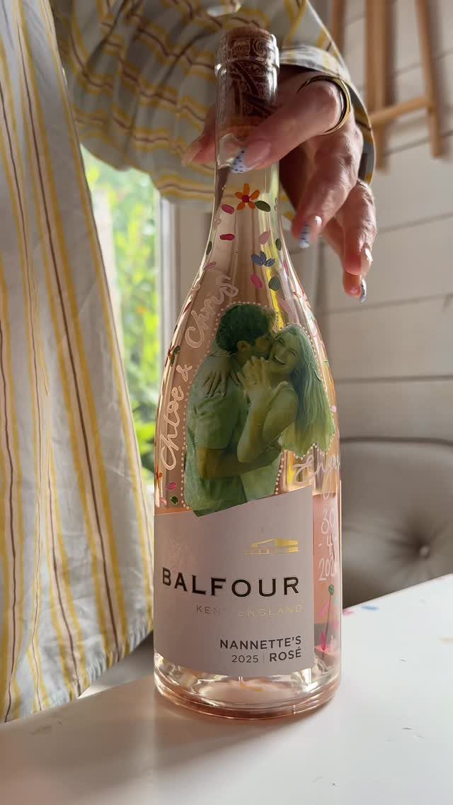 22 Wedding Present Ideas for Couples to Treasure 11 Balfour Rosé wine bottle with a personalized label showing a couple kissing.