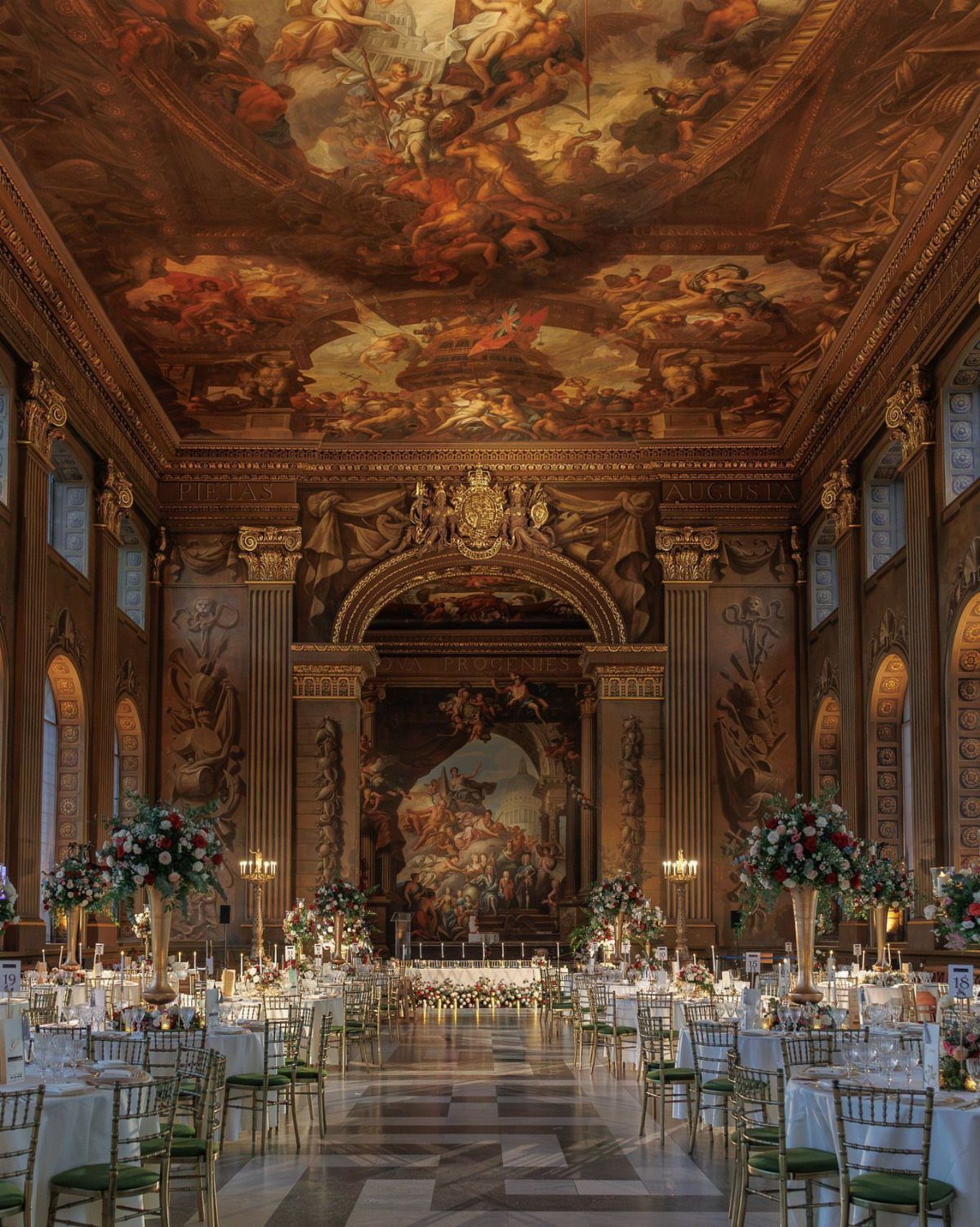 17 Wedding Reception Venues for Every Style and Budget 15 Opulent ballroom with painted ceiling and gold columns set for a wedding reception.