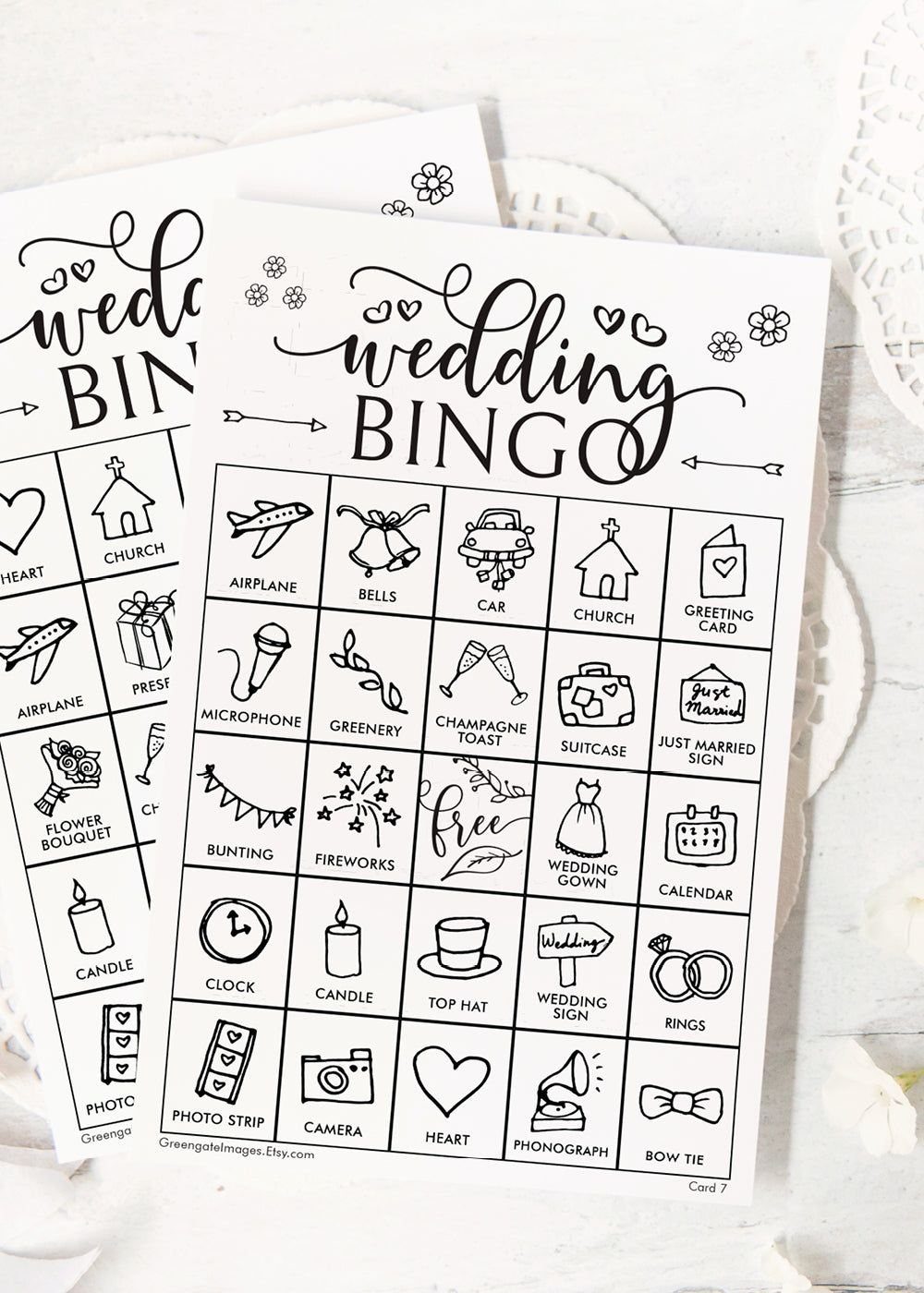 Wedding bingo cards with hand-drawn icons on white paper for guest entertainment.
