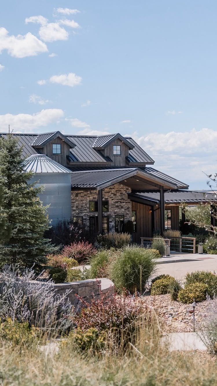 Wedding Venues Western Couples Love: 16 Ideas 6 Modern ranch building with a metal roof and silver silo surrounded by landscaping.