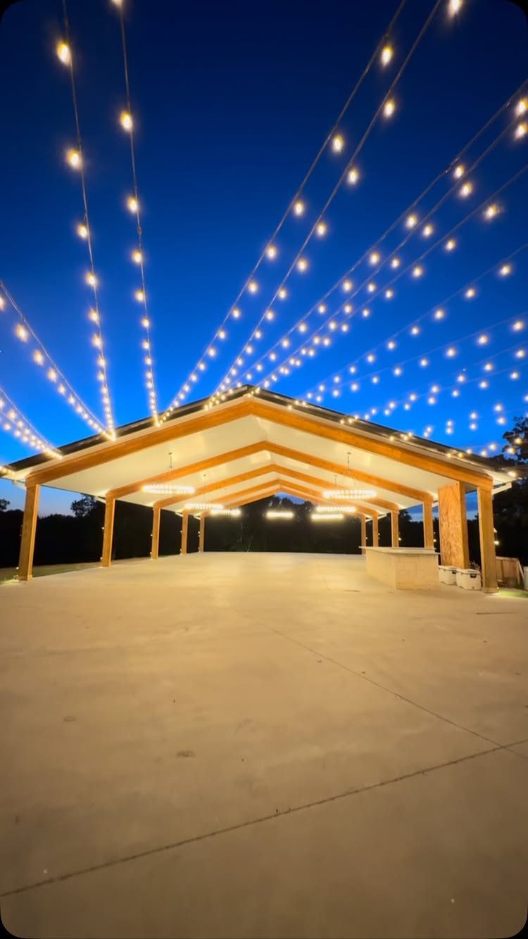 Wedding Venues Western Couples Love: 16 Ideas 11 Open-air wooden pavilion with glowing string lights under a deep blue twilight sky