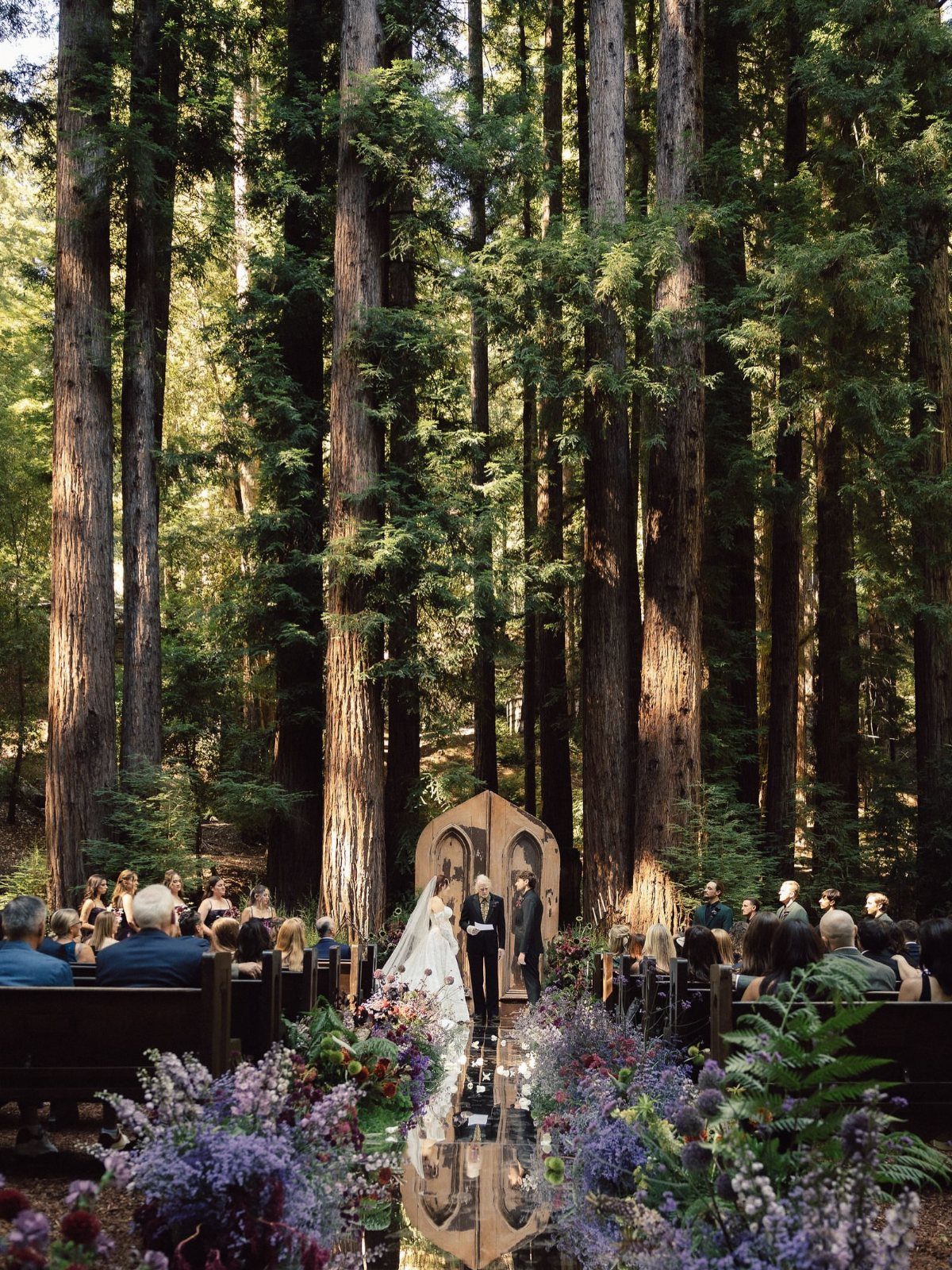 Wedding Venues Western Couples Love: 16 Ideas 8 Wedding ceremony in a redwood forest with guests seated in wooden pews.