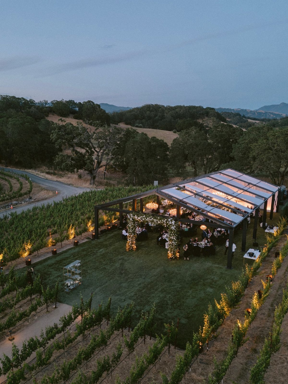 Wedding Venues Western Couples Love: 16 Ideas 14 Outdoor wedding reception tent with clear roof set within a scenic vineyard landscape